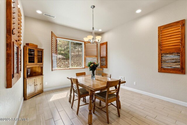 dining space featuring a notable chandelier, baseboards, recessed lighting, light wood-style flooring, and visible vents