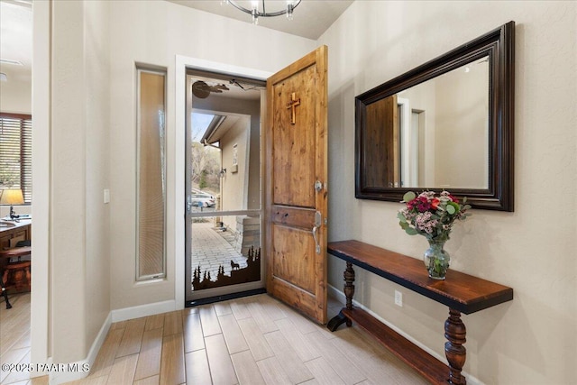entryway featuring light wood-style floors and baseboards