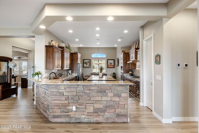 5242 High Cliff Way, Prescott, AZ 86301 - kitchen featuring light stone countertops, backsplash, light wood-style floors, and recessed lighting