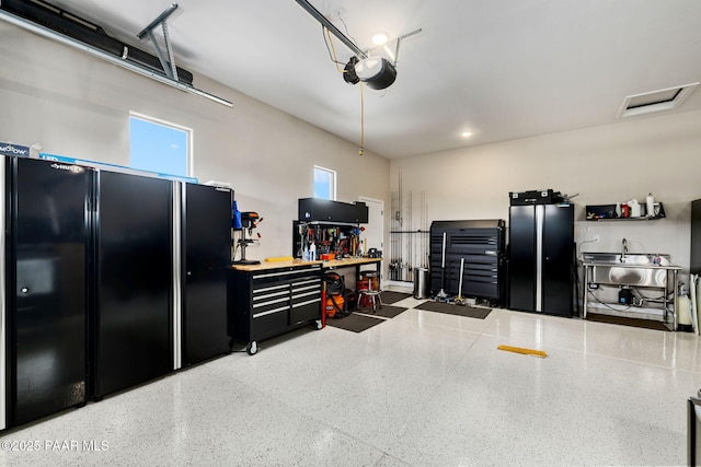 5242 High Cliff Way, Prescott, AZ 86301 - garage with freestanding refrigerator, a workshop area, and a garage door opener