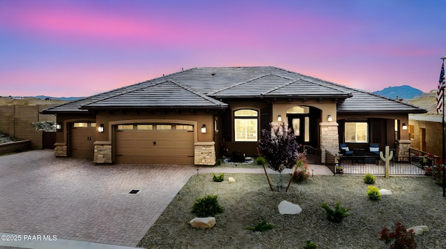 5242 High Cliff Way, Prescott, AZ 86301 - view of front of property featuring an attached garage, stone siding, decorative driveway, stucco siding, and a tiled roof