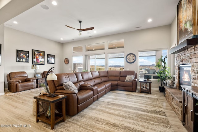 5242 High Cliff Way, Prescott, AZ 86301 - living room featuring a fireplace, a ceiling fan, light wood-type flooring, and recessed lighting