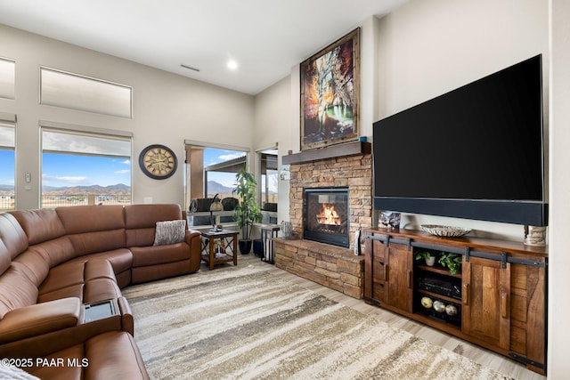 5242 High Cliff Way, Prescott, AZ 86301 - living room featuring a fireplace, wood finished floors, recessed lighting, and a towering ceiling