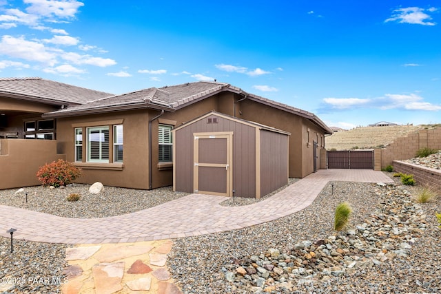 5242 High Cliff Way, Prescott, AZ 86301 - view of side of property featuring a fenced backyard, stucco siding, a patio area, and a tile roof