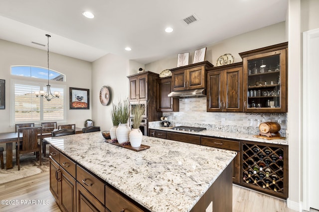 5242 High Cliff Way, Prescott, AZ 86301 - kitchen with under cabinet range hood, stainless steel appliances, light stone counters, pendant lighting, and recessed lighting