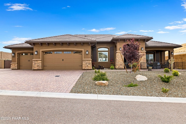 5242 High Cliff Way, Prescott, AZ 86301 - prairie-style home featuring stone siding, decorative driveway, an attached garage, and stucco siding