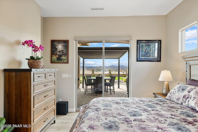 5242 High Cliff Way, Prescott, AZ 86301 - bedroom with access to exterior, light wood finished floors, a mountain view, and baseboards