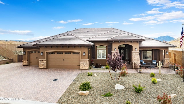 5242 High Cliff Way, Prescott, AZ 86301 - mediterranean / spanish house featuring an attached garage, stucco siding, and a mountain view