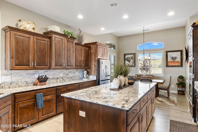 5242 High Cliff Way, Prescott, AZ 86301 - kitchen featuring appliances with stainless steel finishes, light wood-style floors, a center island, decorative backsplash, and recessed lighting