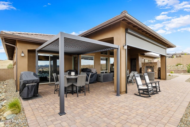 5242 High Cliff Way, Prescott, AZ 86301 - view of patio featuring a lit fireplace, area for grilling, and outdoor dining space