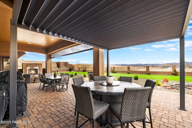 5242 High Cliff Way, Prescott, AZ 86301 - view of patio / terrace featuring a lit fireplace and outdoor dining space