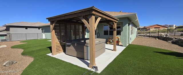 view of yard featuring a gazebo, a patio area, a fenced backyard, and a hot tub