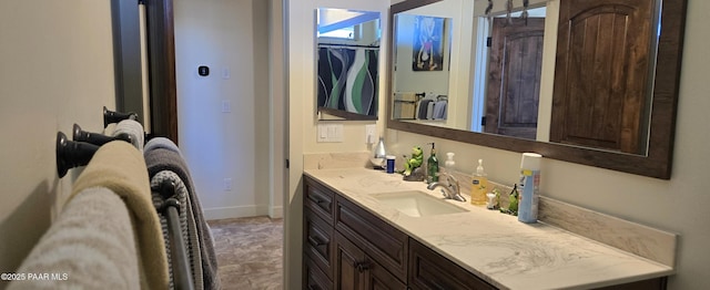 bathroom featuring vanity and baseboards