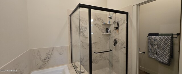 bathroom with a marble finish shower