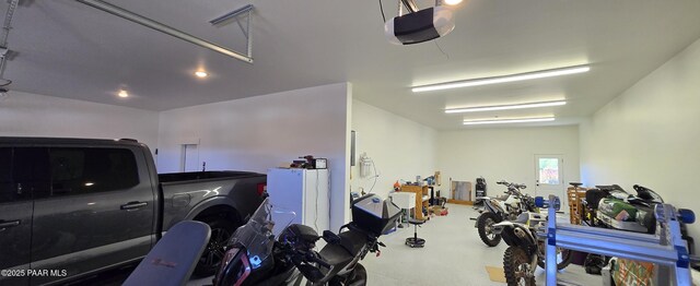 garage with a garage door opener and recessed lighting