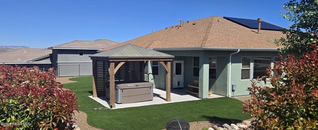 rear view of house featuring a patio, a gazebo, a fenced backyard, and a lawn