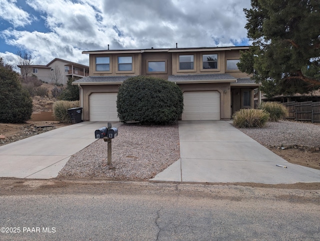 view of front of home featuring a garage, driveway, and stucco siding