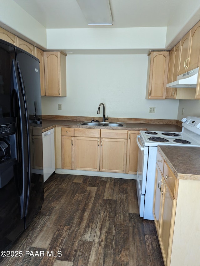 kitchen featuring white appliances, dark wood finished floors, light brown cabinetry, under cabinet range hood, and a sink