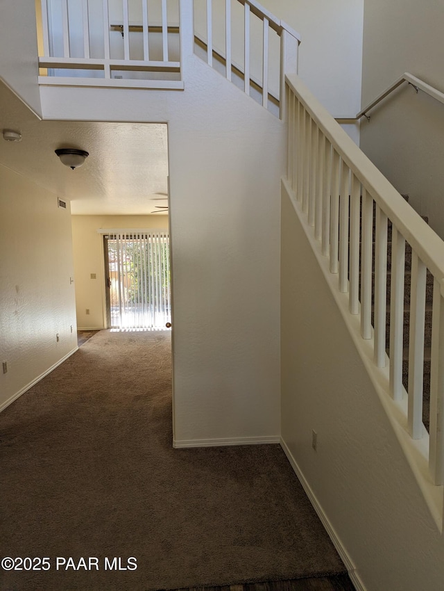 interior space featuring carpet floors and baseboards