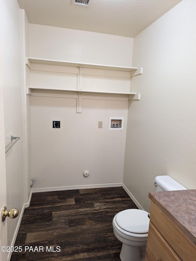 washroom with dark wood-style floors, hookup for a washing machine, hookup for a gas dryer, hookup for an electric dryer, and baseboards