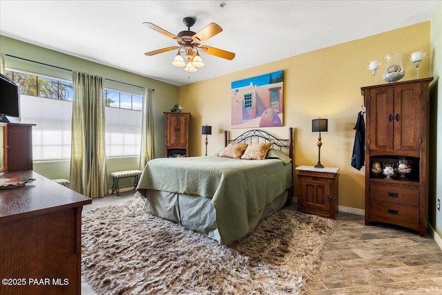 bedroom with baseboards and ceiling fan