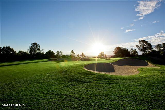surrounding community with a lawn and view of golf course