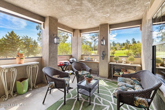 sunroom / solarium featuring concrete flooring