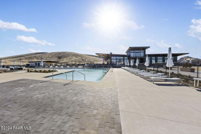 view of swimming pool featuring a patio area and a mountain view