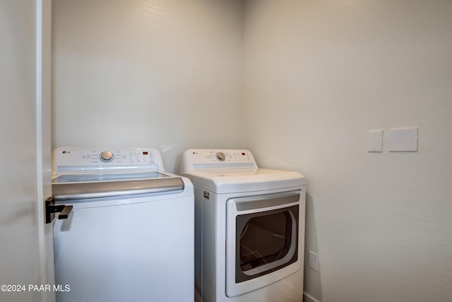 clothes washing area featuring washer and clothes dryer