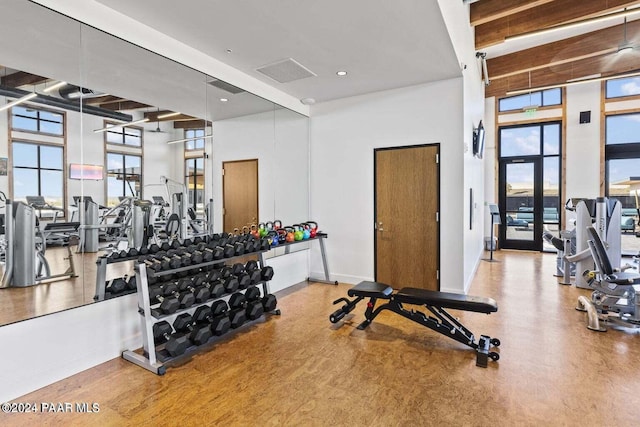 gym featuring a high ceiling and hardwood / wood-style flooring