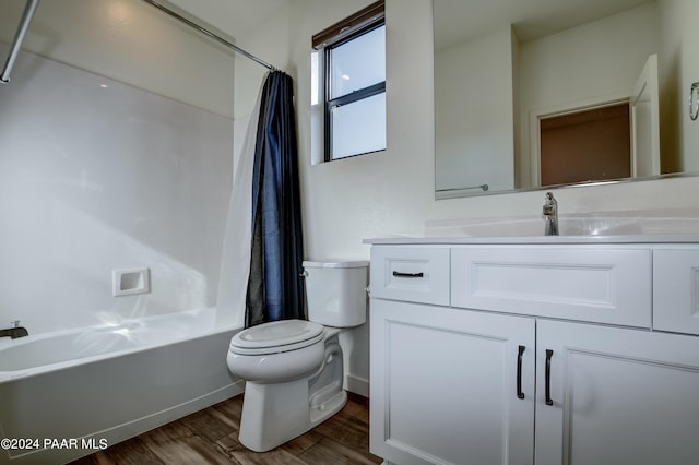 full bathroom with hardwood / wood-style floors, vanity, shower / bath combo, and toilet