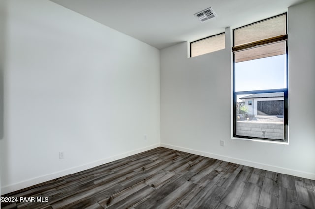 spare room featuring dark hardwood / wood-style flooring