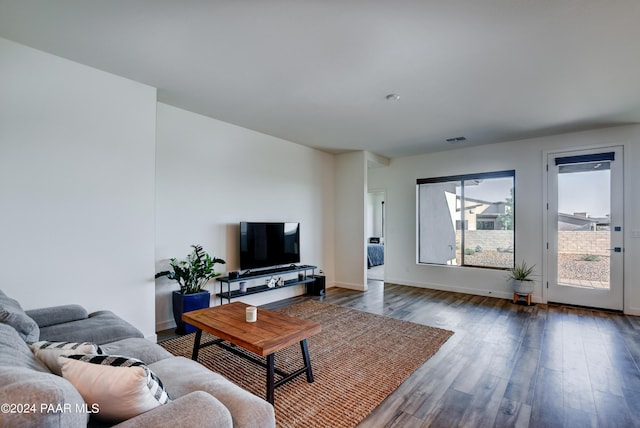 living room with dark hardwood / wood-style flooring