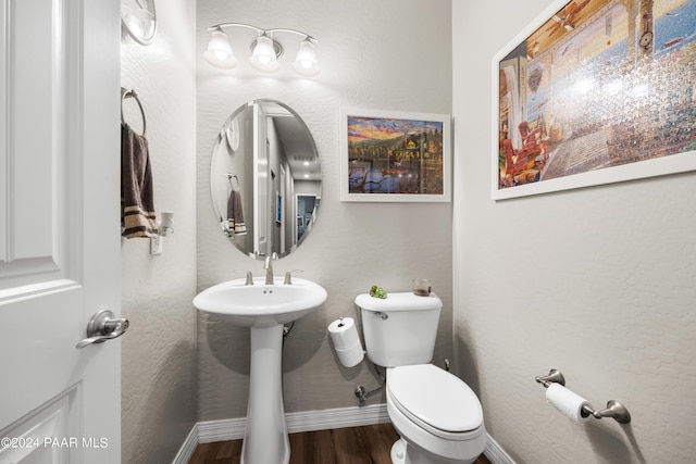 bathroom featuring sink, toilet, and hardwood / wood-style flooring