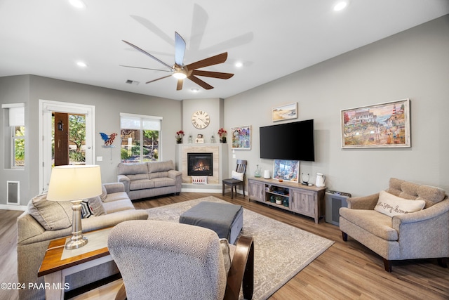 living room featuring ceiling fan and hardwood / wood-style flooring