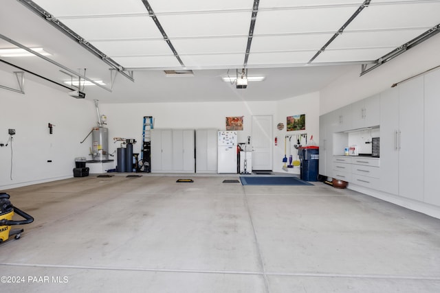 garage featuring water heater and a garage door opener