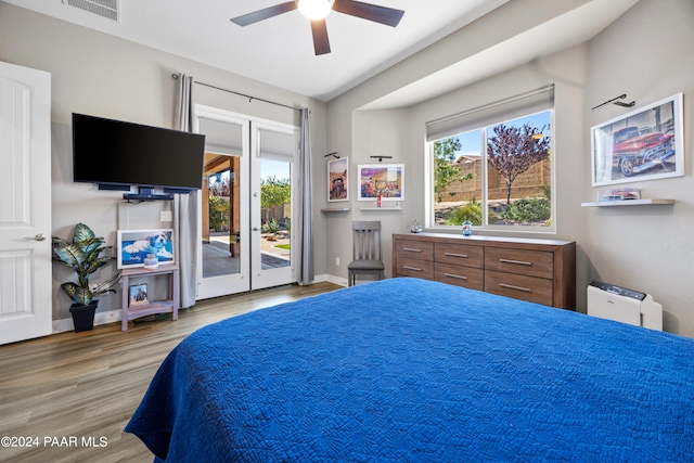 bedroom with access to exterior, light wood-type flooring, and ceiling fan