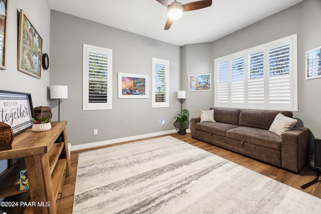 living room with ceiling fan, plenty of natural light, and light hardwood / wood-style floors