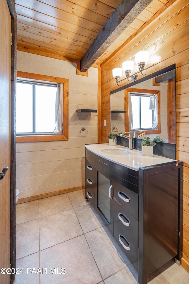 bathroom featuring tile patterned flooring, beamed ceiling, a wealth of natural light, and wooden ceiling