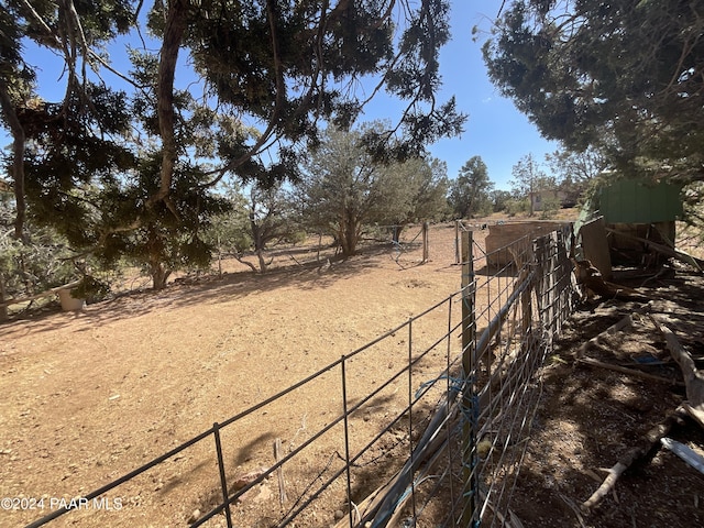 view of yard featuring a rural view and fence