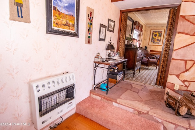 hallway with heating unit and wallpapered walls