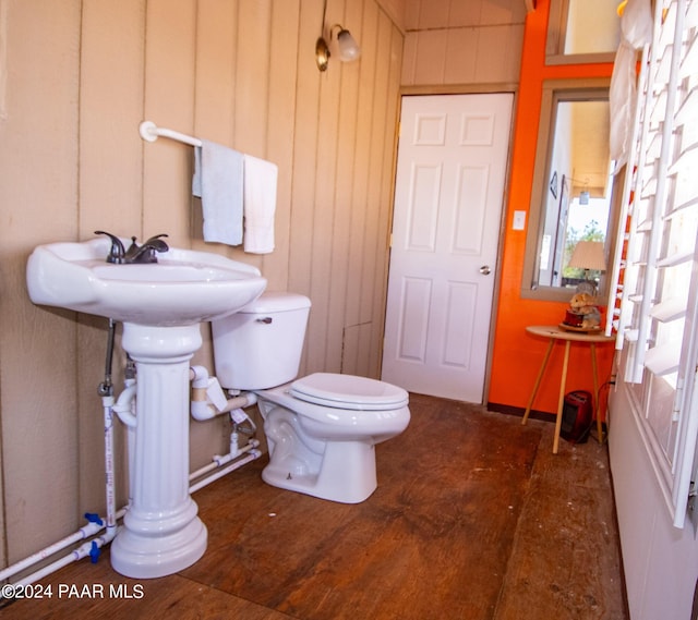 bathroom with wood finished floors and toilet