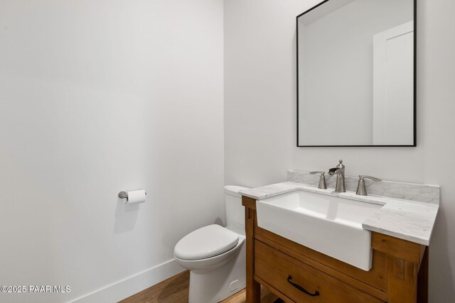 1148 S Lakeview Dr, Prescott, AZ 86301 - half bath with baseboards, toilet, wood finished floors, and vanity