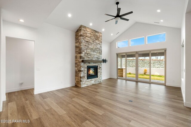 1148 S Lakeview Dr, Prescott, AZ 86301 - unfurnished living room with light wood-type flooring, high vaulted ceiling, ceiling fan, and a fireplace
