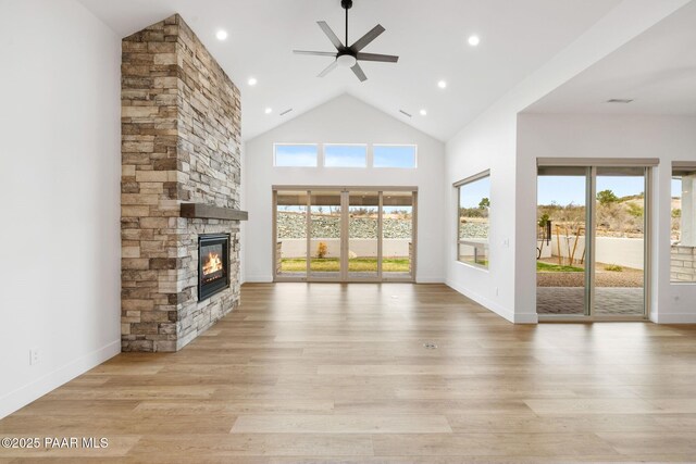 1148 S Lakeview Dr, Prescott, AZ 86301 - unfurnished living room featuring a fireplace, plenty of natural light, a ceiling fan, and light wood finished floors
