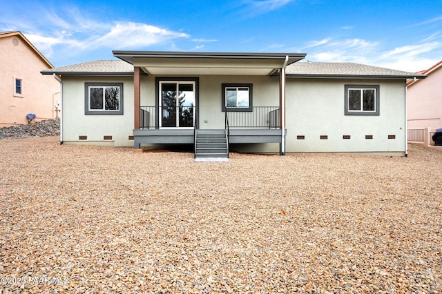 view of front of home with a porch, stucco siding, roof with shingles, and crawl space