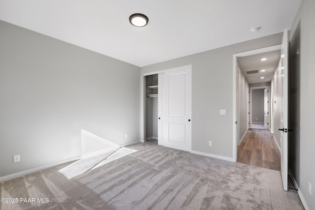 unfurnished bedroom featuring a closet, baseboards, and carpet flooring