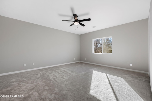 spare room featuring visible vents, a ceiling fan, baseboards, and carpet floors