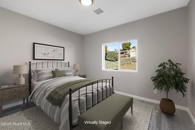 carpeted bedroom featuring visible vents and baseboards