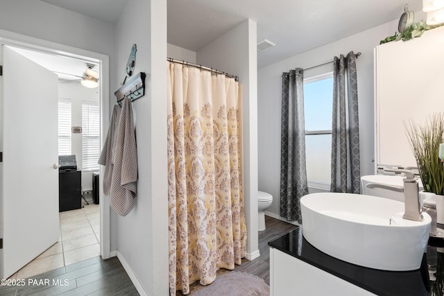 bathroom featuring ceiling fan, wood-type flooring, toilet, and vanity